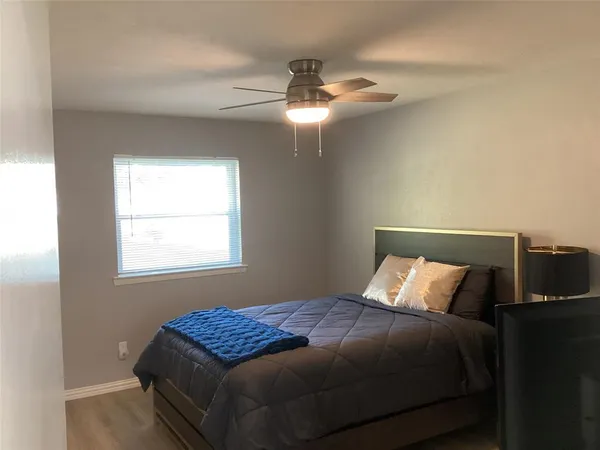 a bedroom with a bed and window