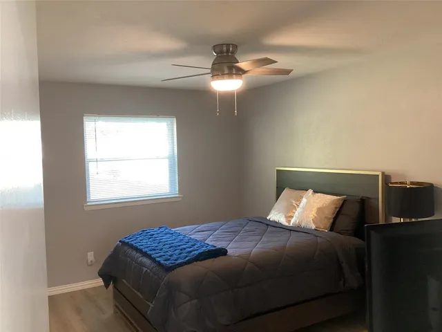 a bedroom with a bed and window
