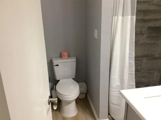 a white toilet sitting next to a small sink