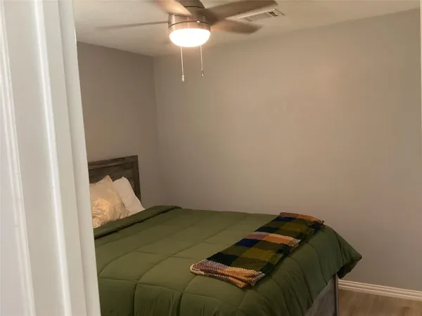 a bed in a bedroom next to a window