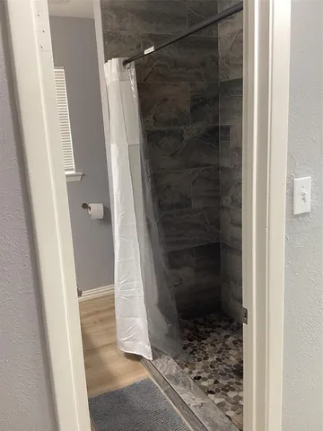 a bathroom with a glass door shower