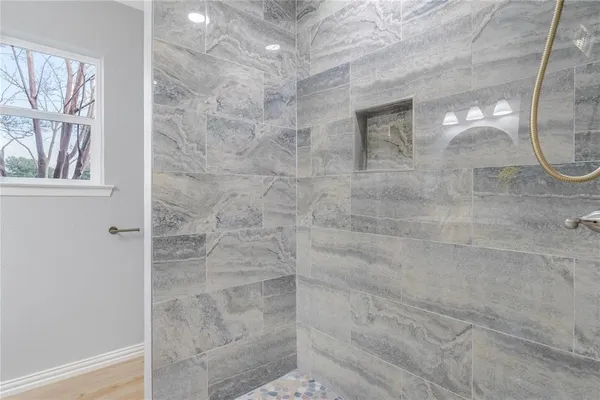 a bathroom with a glass shower door