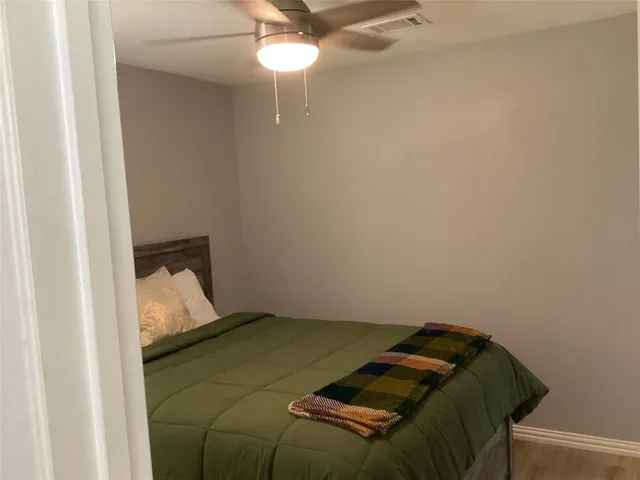 a bed in a bedroom next to a window