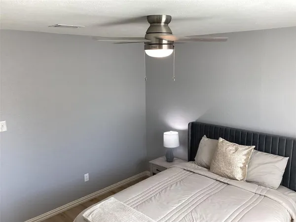 a bedroom with a bed and chandelier
