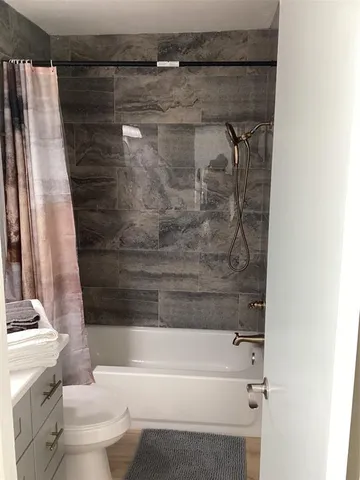 a bathroom with a bathtub and a toilet