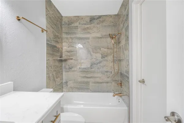 a bathroom with a bathtub and shower