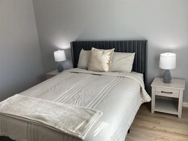 a bedroom with a bed and a lamp