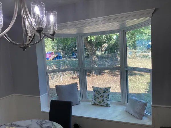 a outdoor dining room with furniture and window