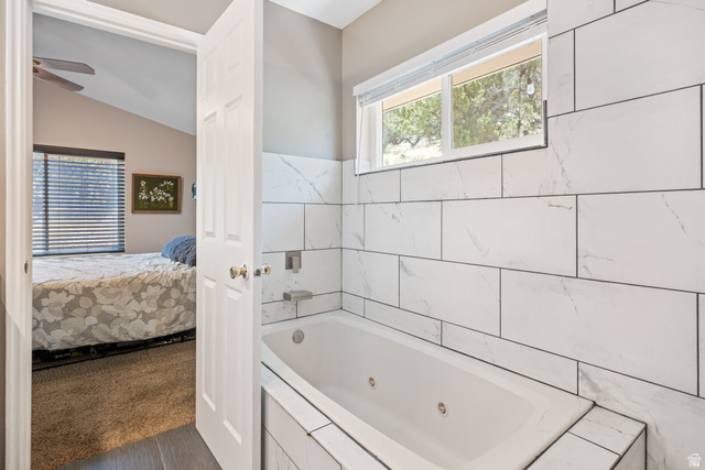 790 East Fiddlers Canyon Road Cedar City, UT 84721 - Photo 17 of 35 Soaking tub with white subway tile surround, featuring integrated wall-mounted fixtures