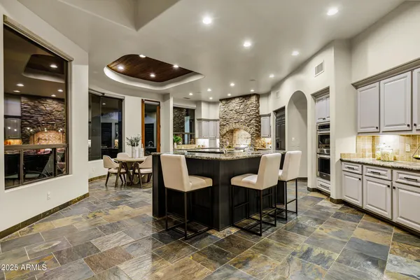 a living room with furniture a large window and a table
