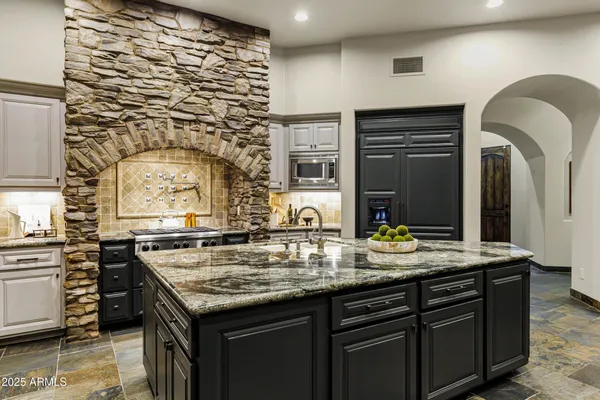 a kitchen with a sink stove and cabinets