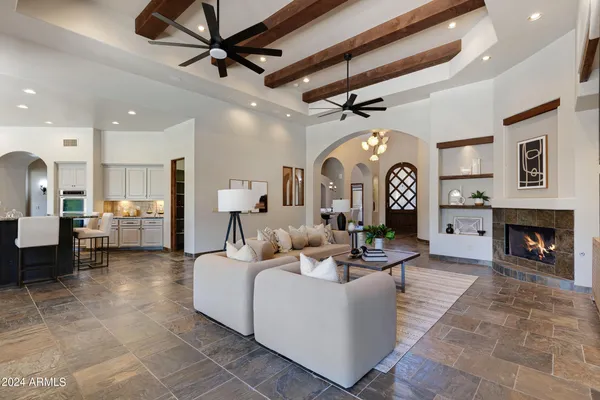 a front view of a house with a yard and potted plants