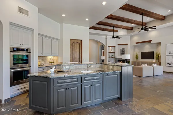 a view of room with windows and ceiling fan