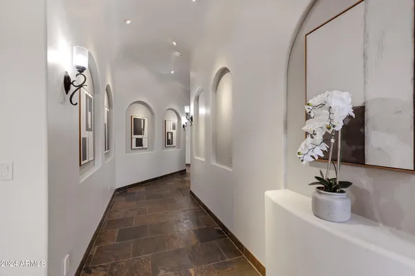 a view of a hallway with a ceiling fan