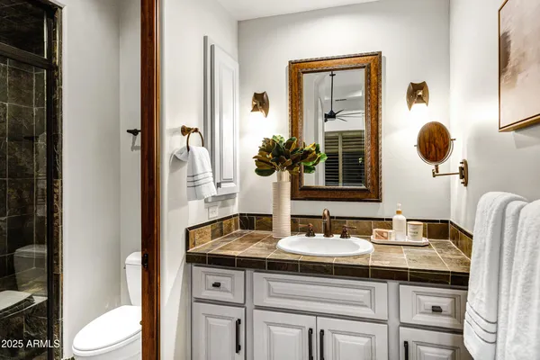 a front view of a house with a garden and parking