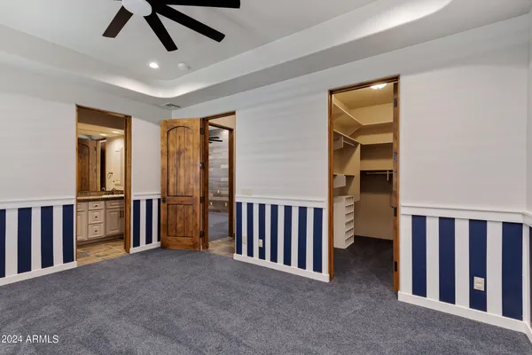 a view of room with ceiling fan and window