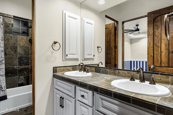 a view of a patio with table and chairs potted plants with wooden fence