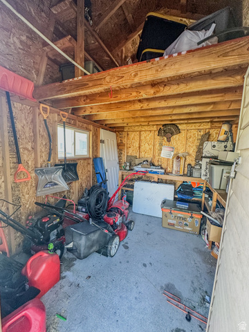 680 Timpie Road Tooele, UT 84074 - Photo 26 of 31 Detached utility shed featuring exposed wood framing, a concrete floor, and an overhead storage loft