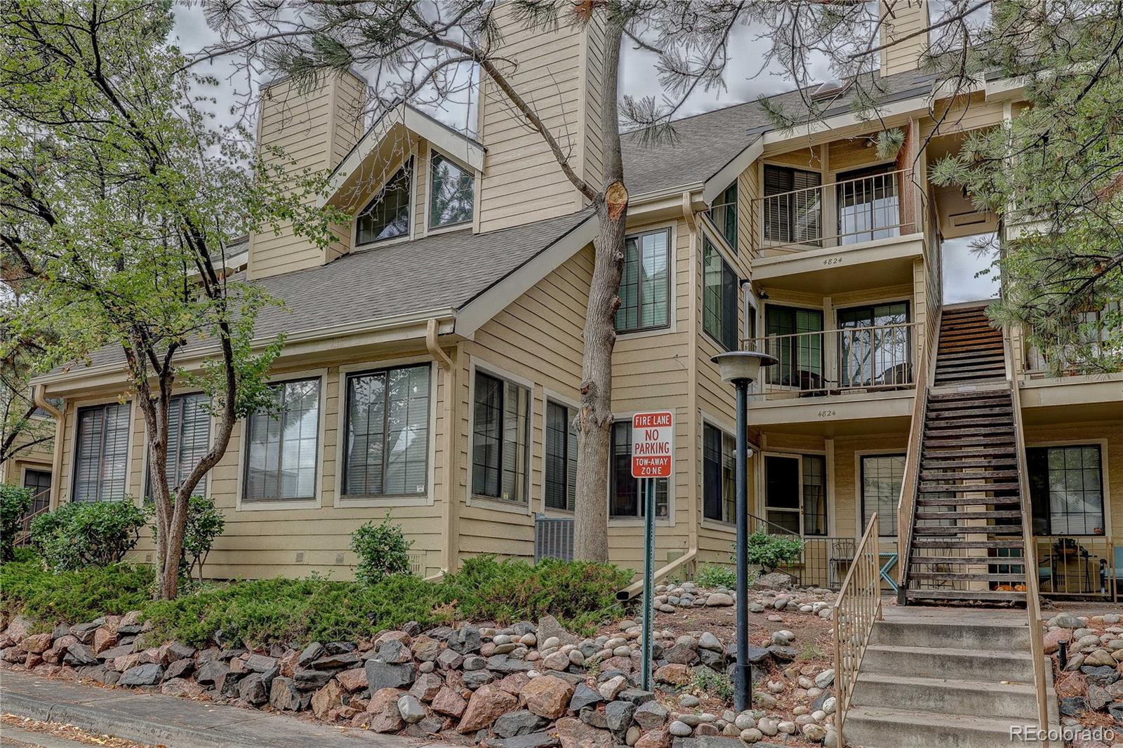 4824 East Kentucky Avenue, Unit C Denver, CO 80246 - Photo 1 of 17 a front view of a house with garden