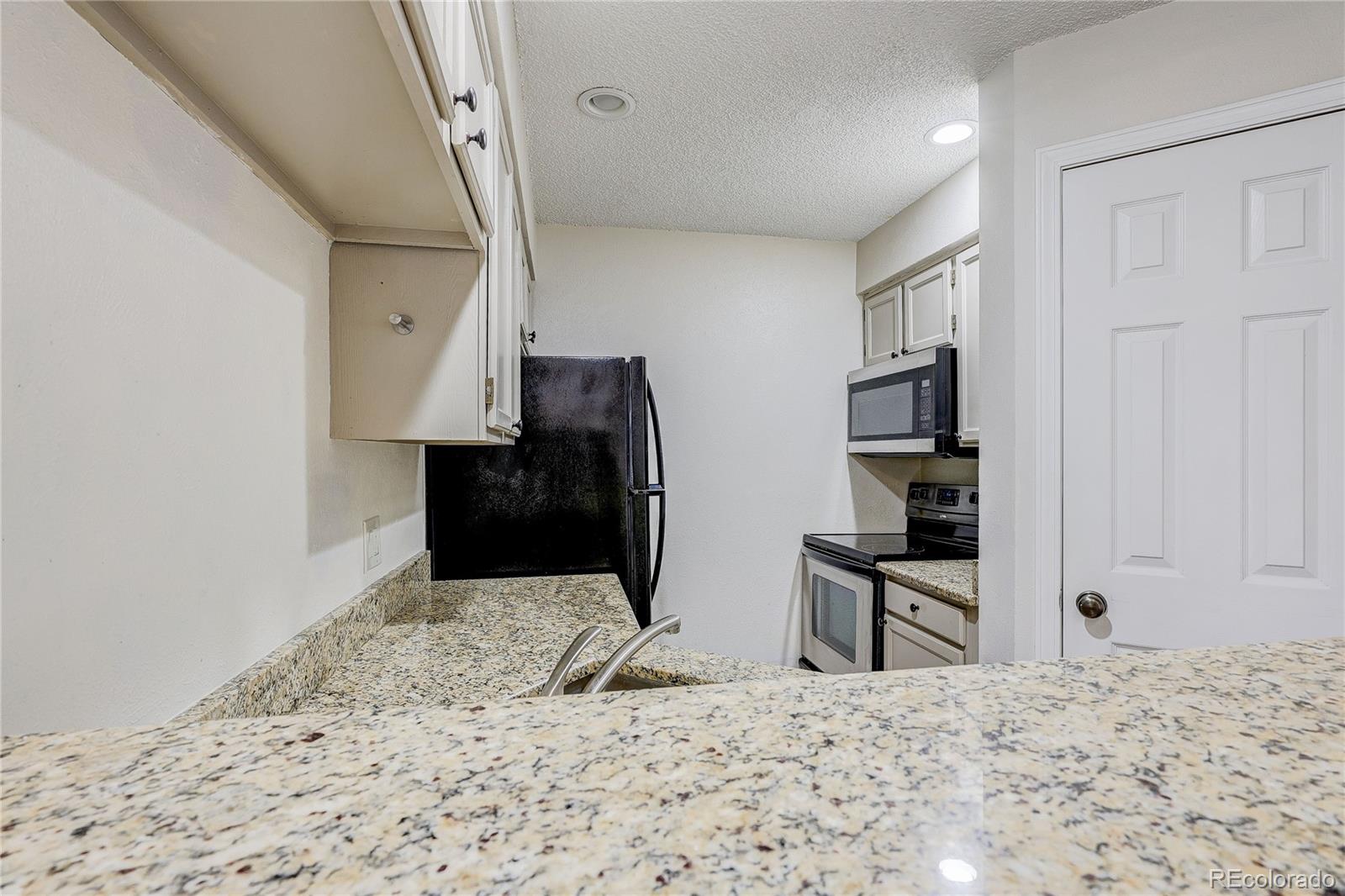 4824 East Kentucky Avenue, Unit C Denver, CO 80246 - Photo 8 of 17 a view of a livingroom with wooden floor and workspace
