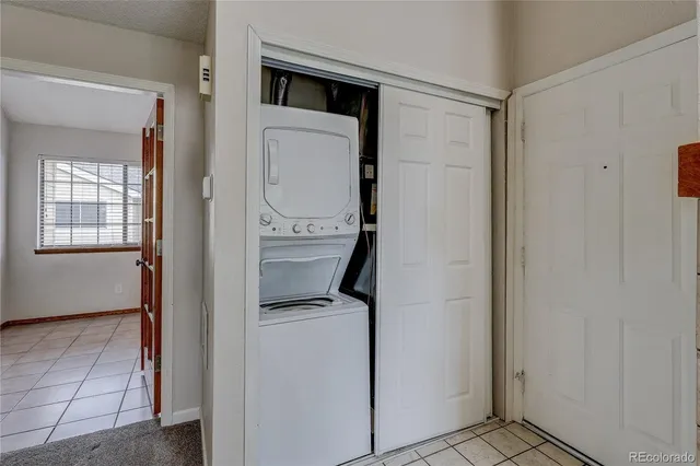 a utility room with closet dryer and washer