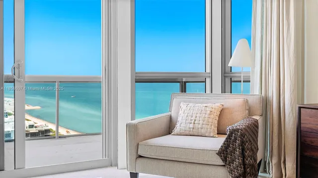 a living room with a couch and a large window with garden view