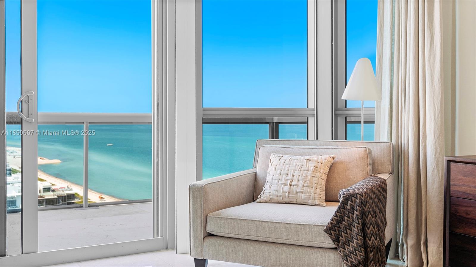 101 20th Street, Unit 3903 Miami Beach, FL 33139 - Photo 15 of 38 a living room with a couch and a large window with garden view