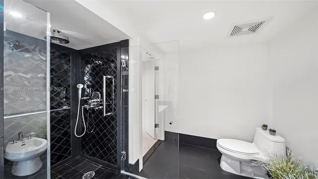 a bathroom with a sink double vanity granite tub shower and a mirror