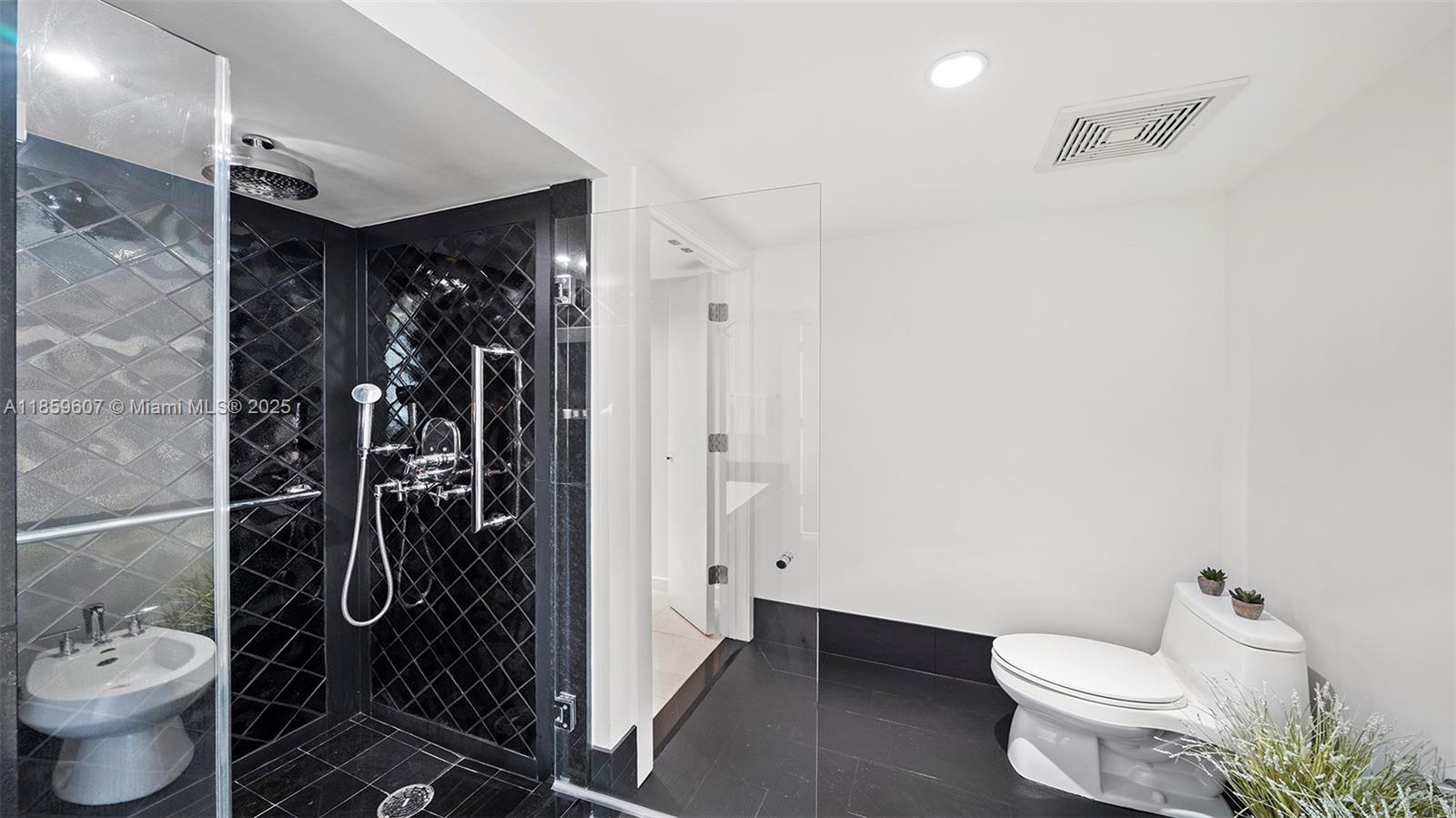 101 20th Street, Unit 3903 Miami Beach, FL 33139 - Photo 18 of 38 a bathroom with a toilet and a shower