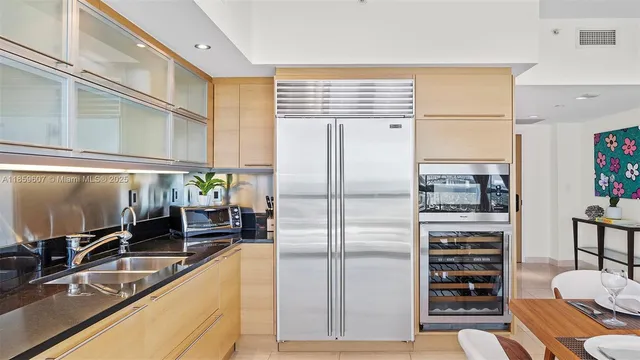 a kitchen with refrigerator and cabinets