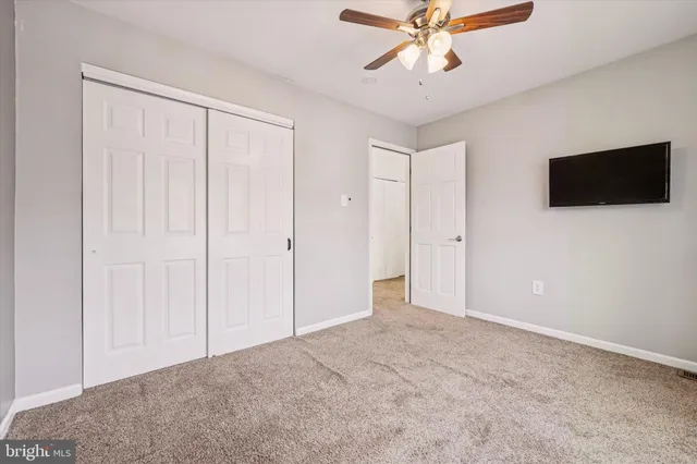a front view of a house with iron fence
