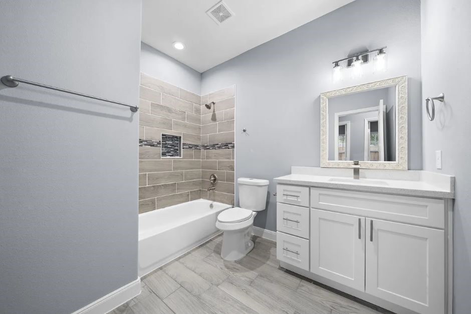 5222 Bataan Road Houston, TX 77033 - Photo 13 of 22 Spa-inspired bathroom showcasing dual vanities, sleek countertops, and upscale contemporary finishes.