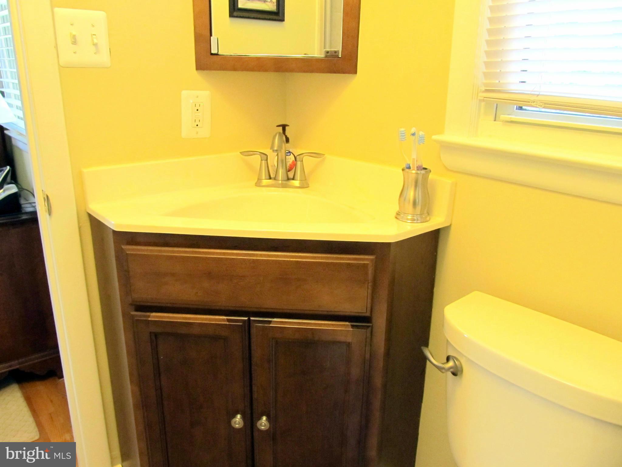 126 Kingbrook Road Linthicum, MD 21090 - Photo 11 of 23 a bathroom with a sink and a mirror