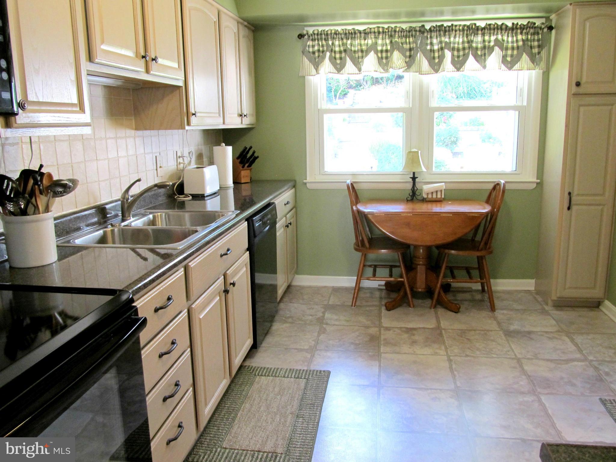126 Kingbrook Road Linthicum, MD 21090 - Photo 6 of 23 a kitchen with a sink dining table and chairs