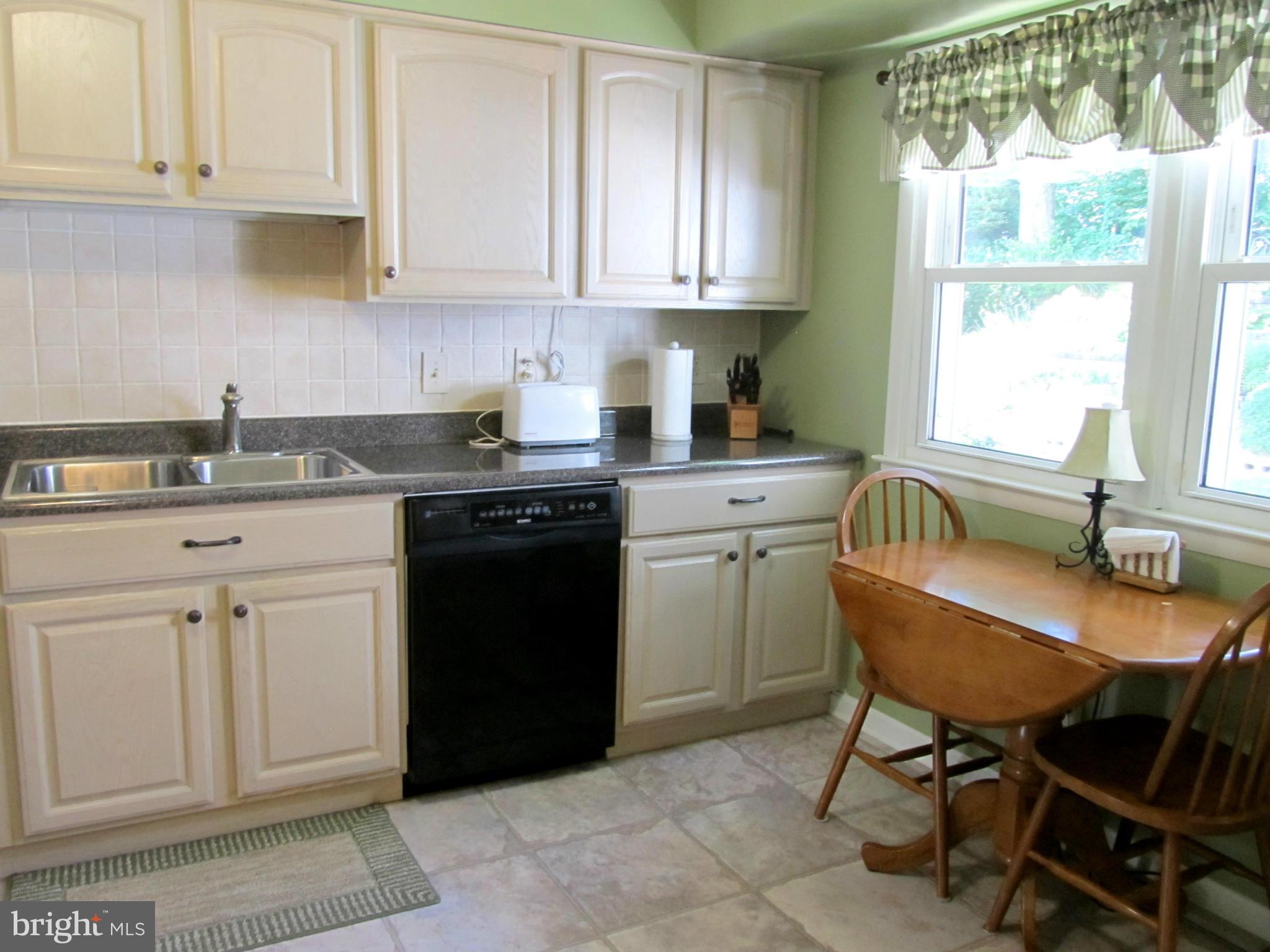 126 Kingbrook Road Linthicum, MD 21090 - Photo 7 of 23 a kitchen with granite countertop white cabinets and white appliances
