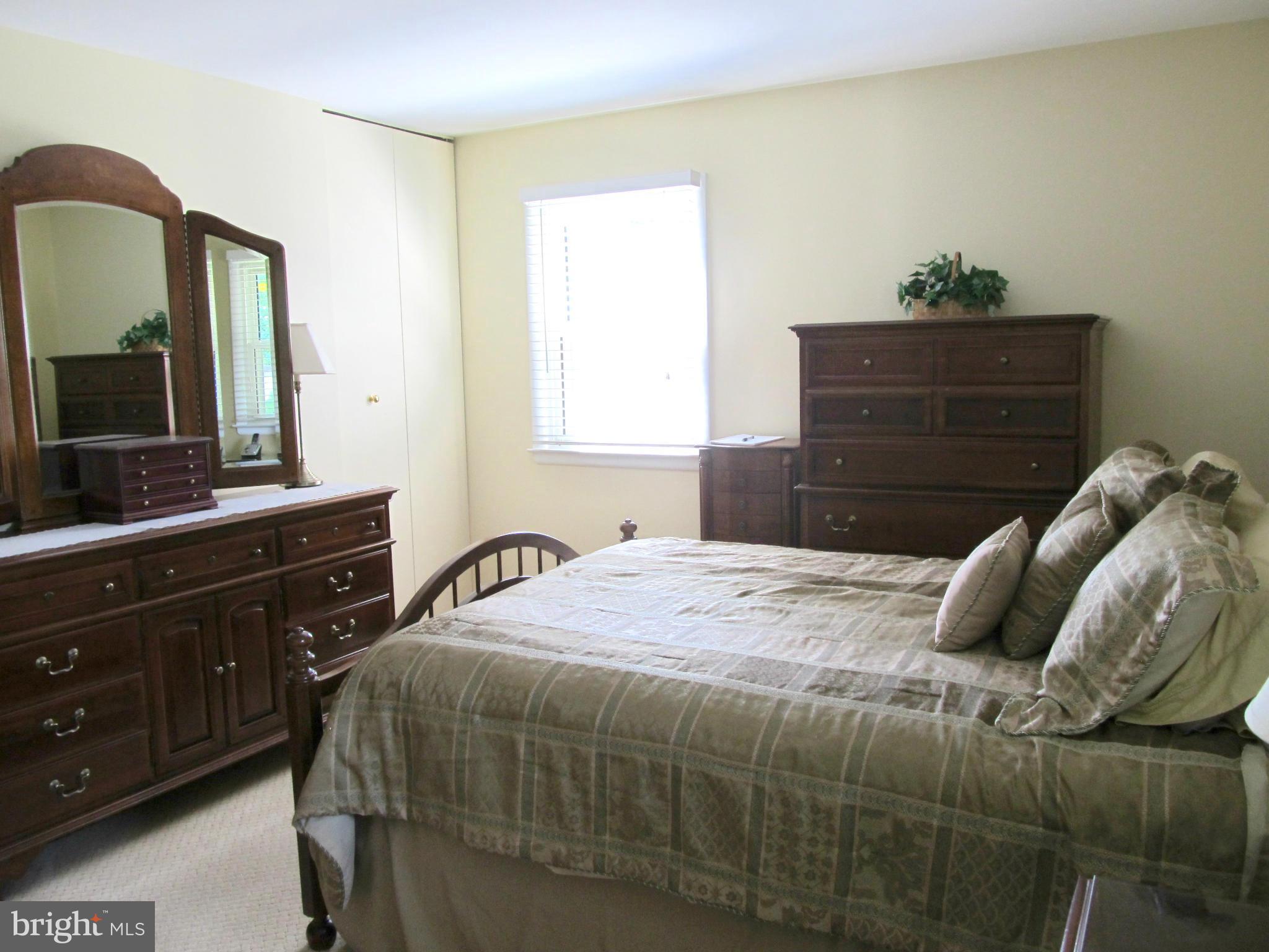 126 Kingbrook Road Linthicum, MD 21090 - Photo 9 of 23 a bedroom with a bed and a mirror on dresser
