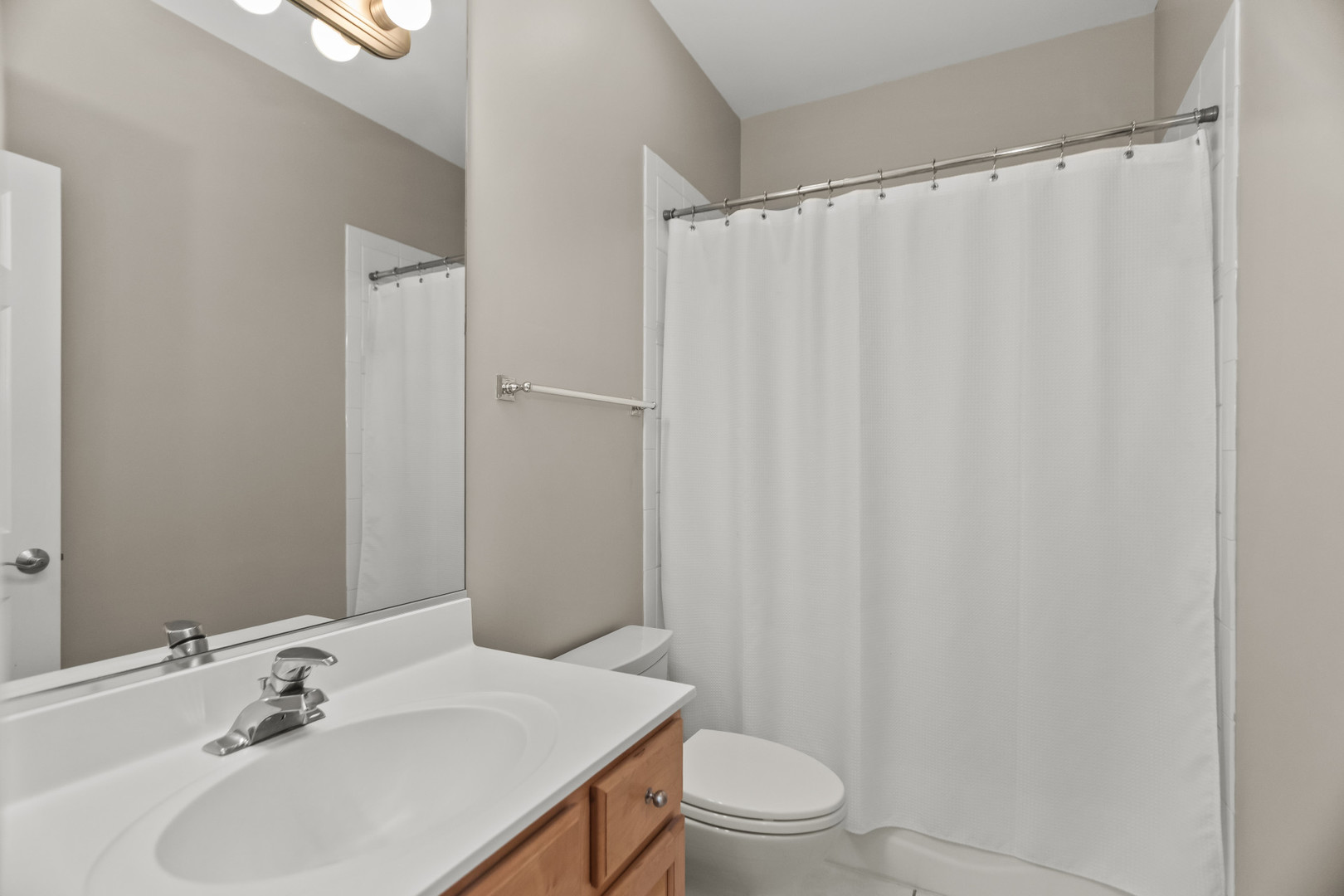 1033 West Taylor Street, Unit 3E Chicago, IL 60607 - Photo 15 of 22 a bathroom with a sink a toilet and shower curtain
