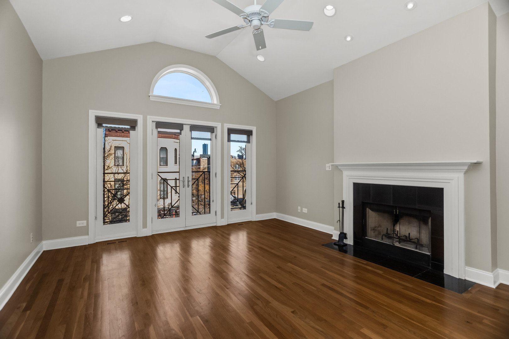 1033 West Taylor Street, Unit 3E Chicago, IL 60607 - Photo 3 of 22 an empty room with wooden floor fireplace and windows