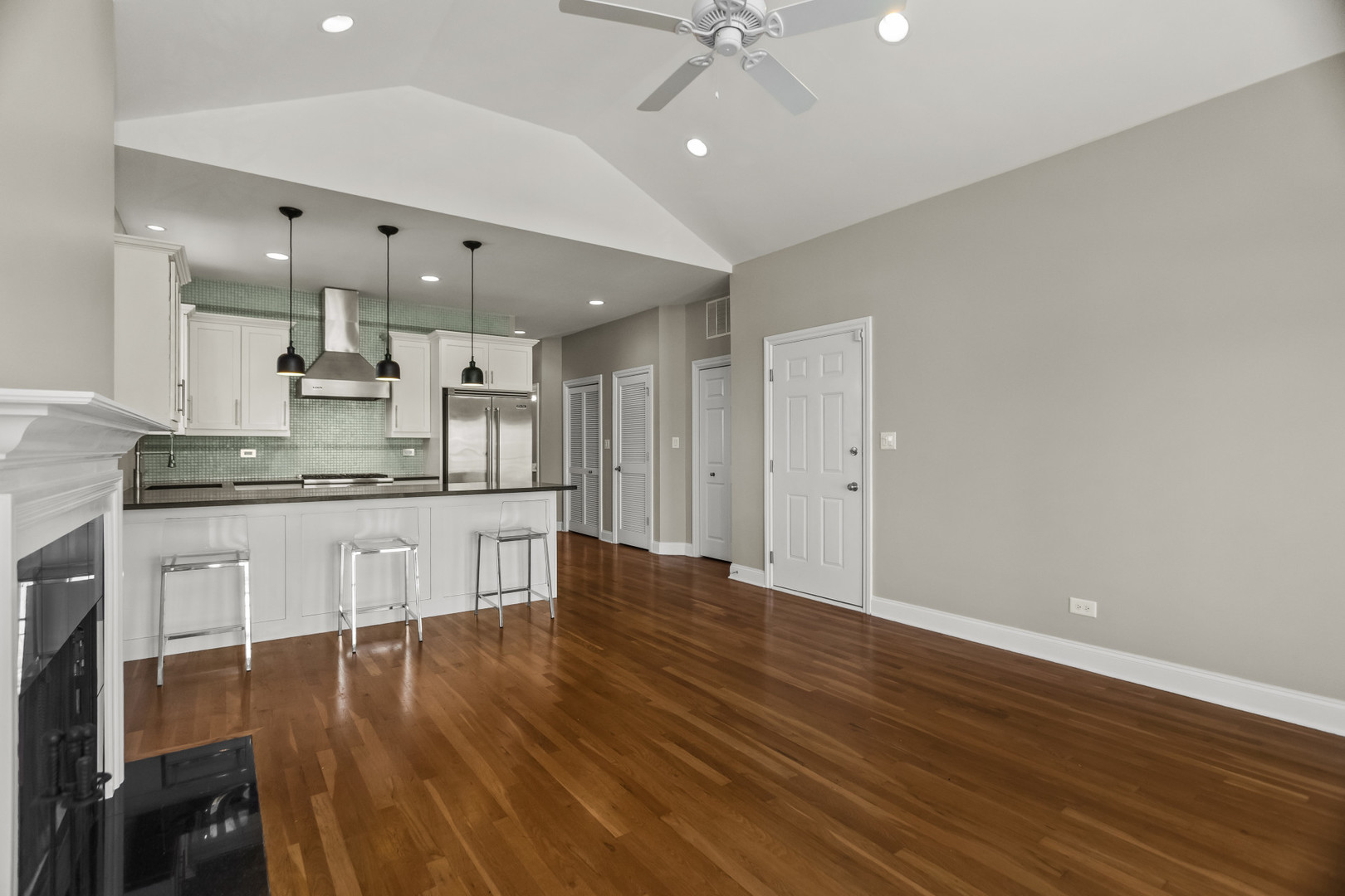 1033 West Taylor Street, Unit 3E Chicago, IL 60607 - Photo 5 of 22 a kitchen with kitchen island white cabinets and stainless steel appliances