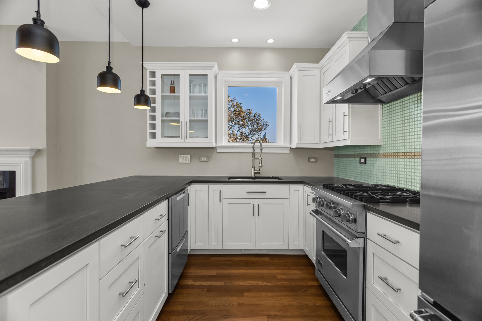 1033 West Taylor Street, Unit 3E Chicago, IL 60607 - Photo 7 of 22 a kitchen with granite countertop a sink stainless steel appliances and cabinets