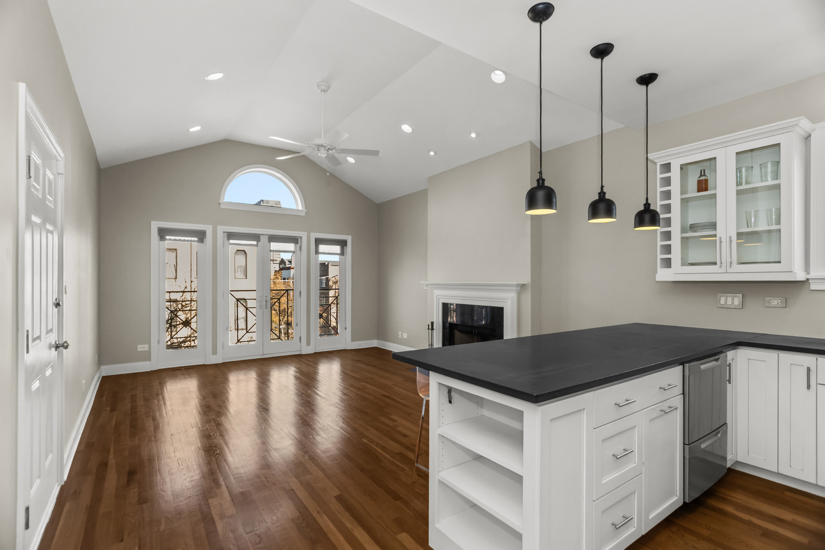 1033 West Taylor Street, Unit 3E Chicago, IL 60607 - Photo 8 of 22 a kitchen with granite countertop white cabinets and wooden floor