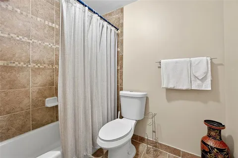a white toilet sitting next to a bathroom sink