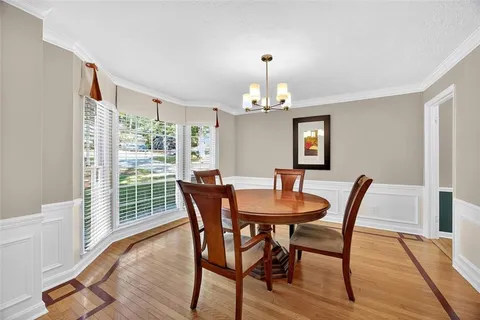 a view of a dining room with furniture window and wooden floor
