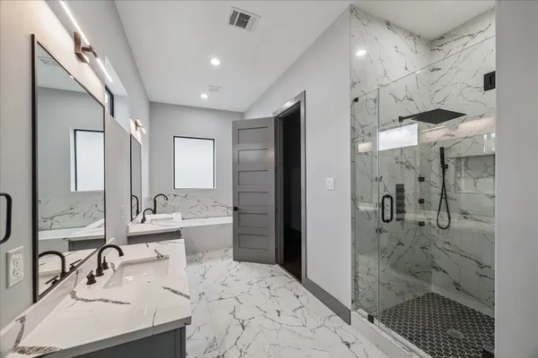 a bathroom with a bathtub and a sink
