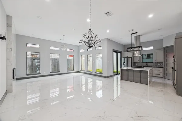 a view of a room with stairs and a chandelier