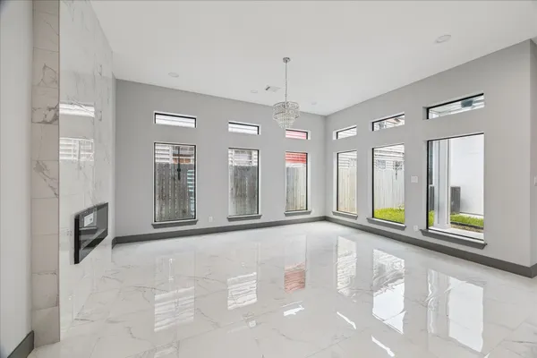 a view of kitchen with refrigerator and cabinets