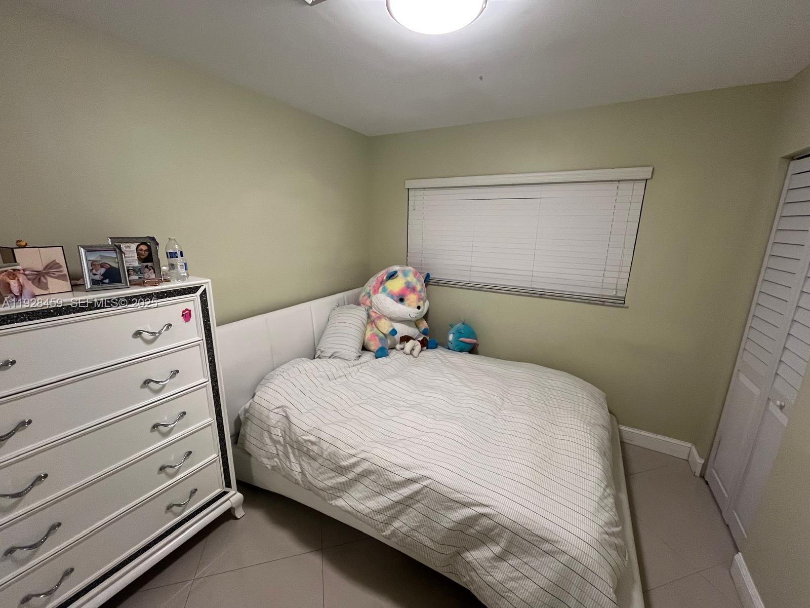 3520 Southwest 104th Avenue Miami, FL 33165 - Photo 13 of 38 a bedroom with a bed and a dresser