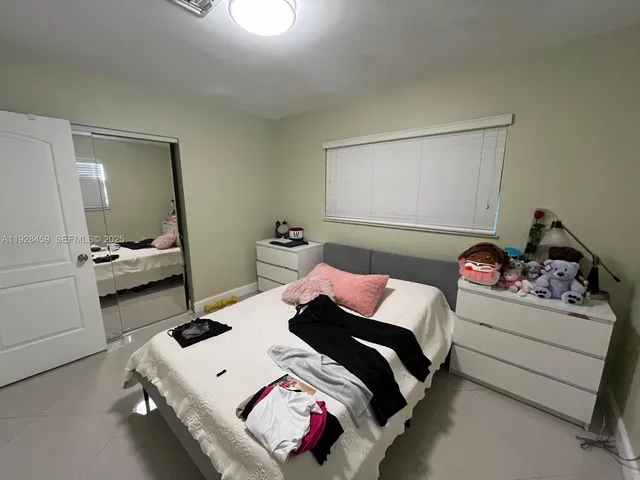 a bedroom with bed and a window