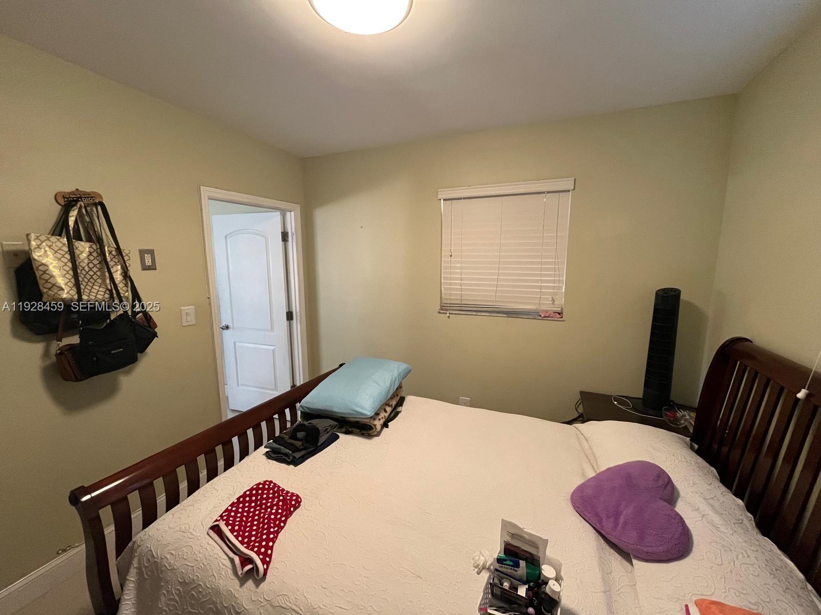 3520 Southwest 104th Avenue Miami, FL 33165 - Photo 17 of 38 a bedroom with a bed and wooden floor