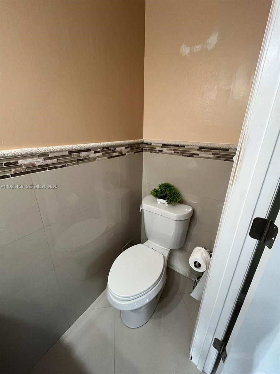 3520 Southwest 104th Avenue Miami, FL 33165 - Photo 20 of 38 a white toilet sitting next to a small bathroom